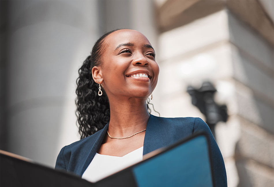 A smiling business woman outside a courtroom