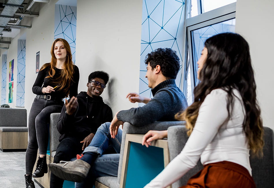 Four students talking to each other.