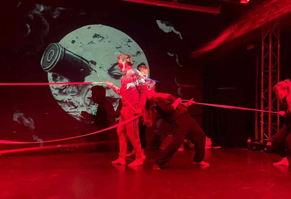 Two dancers performing a contempory dance on stage.