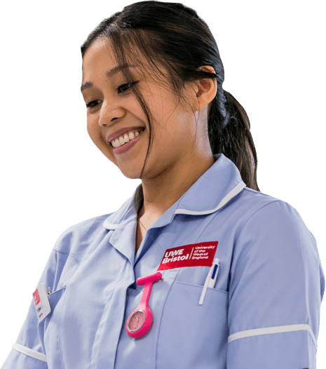 A smiling Adult Nursing degree student wearing a pale blue nurses uniform with the UWE Bristol logo on it