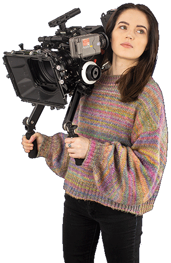 A Filmmaking degree student holding filmmaking equipment