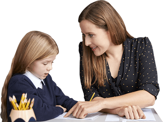 A Primary Initial Teacher Education degree student assisting a child with their writing